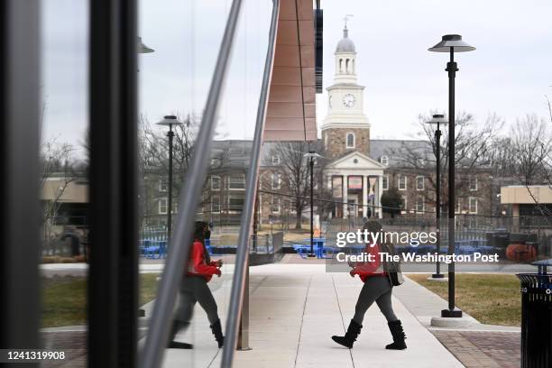 The brand new Tyler Hall reflects a student as Holmes Hall looms in the background at Morgan State University February 07, 2022 in Baltimore, MD....