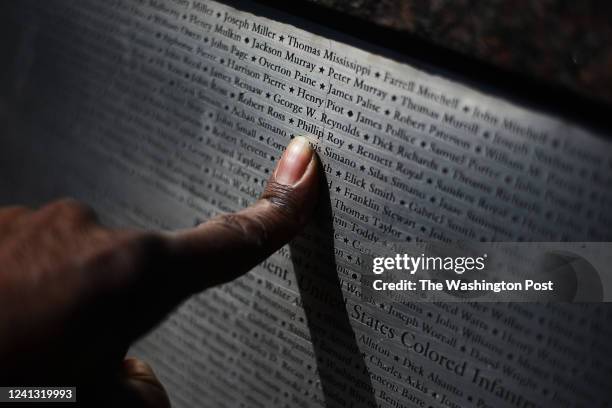 Well known photographer Roy Lewis puts his finger to the name of his great great grand-father Phillip Roy, born 1832, who served in the 87 infantry...