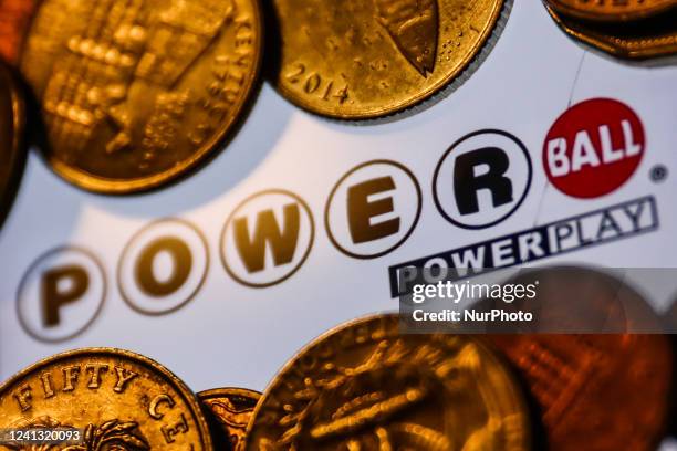 Powerball logo displayed on a phone screen and coins are seen in this illustration photo taken in Krakow, Poland on June 14, 2022.