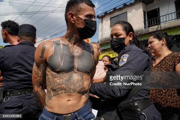 An alleged gang member kisses his family before being brought into a detention center on April 25, 2022 in San Salvador, El Salvador.