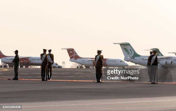 Members of Iranian Army honor guard stand at attention next to Iranian Mahan Air and Qeshm Air Airlines aircrafts at Tehrans International Mehrabad...