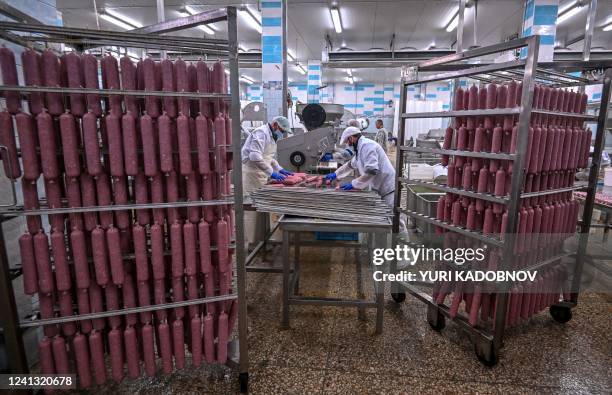 Workers produce sausages at Berdyansk Meat Processing Plant in Berdyansk, amid the ongoing Russian military action in Ukraine, on June 14, 2022.