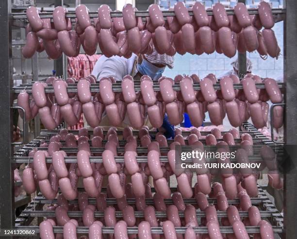 Worker produces sausages at Berdyansk Meat Processing Plant in Berdyansk, amid the ongoing Russian military action in Ukraine, on June 14, 2022.