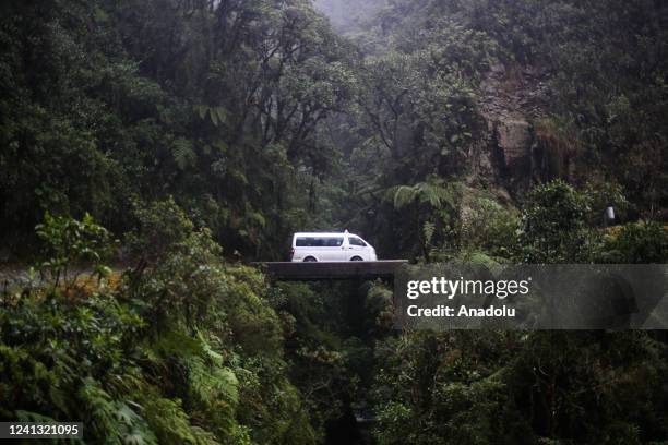 Vehicle passes through the Devil Bridge, a wooden space for cross from one side to another on the Death Road in Los Yungas, La Paz, Bolivia on June...