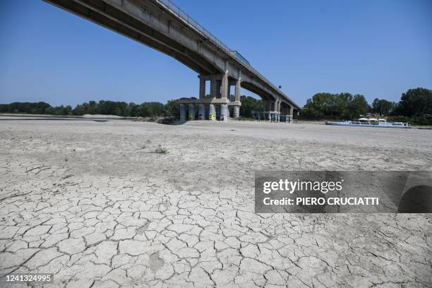 View shows the dessicated bed of the river Po in Boretto, northeast of Parma, on June 15, 2022. - According to the river observatory, the drought...