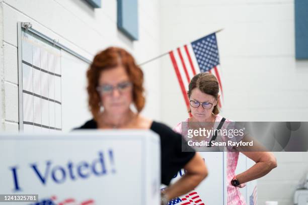 People cast their votes at a polling station during midterm primary elections on June 14, 2022 in Summerville, South Carolina. South Carolina races...
