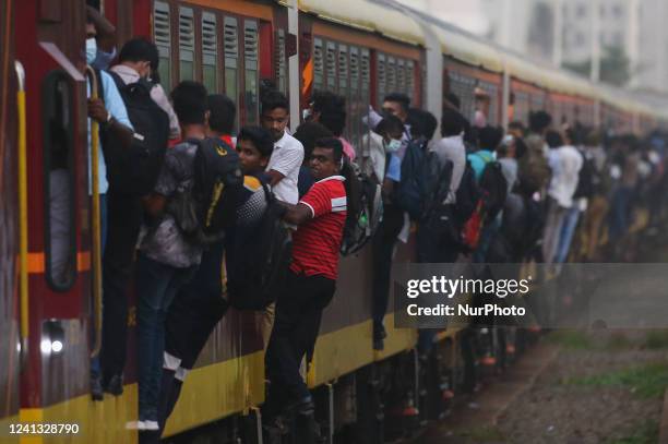 Passengers travel on a crowded train in Colombo on June 15, 2022.