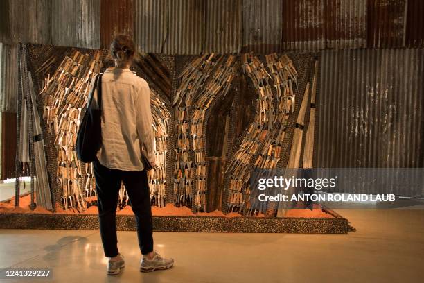 Visitor looks at a work by Wajukuu Art Project from Kenya at the documenta Halle, one of the venues of the documenta fifteen contemporary art...