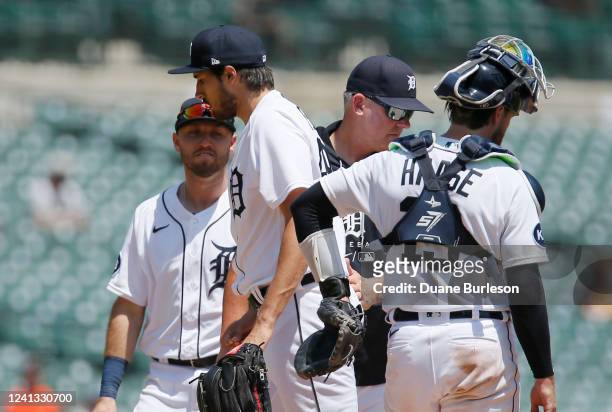 Alex Faedo of the Detroit Tigers is pulled by manager A.J. Hinch with catcher Eric Haase and third baseman Kody Clemens on the mound during the...