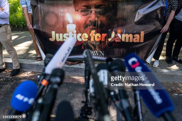 Human rights activists hold a banner calling for justice for the late Jamal Khashoggi during an event to rename the street outside the Embassy of the...