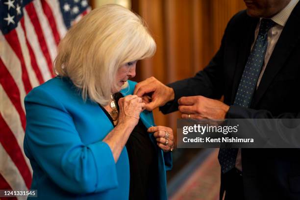 Rep. Connie Conway borrows Rep. David Valadao s Member pin before posing for photos following a ceremonial swearing-in ceremony in the Rayburn room...