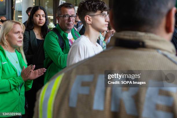 Firefighters provide a guard of honour as survivors and the bereaved walk from Grenfell Tower. Grenfell Tower fire survivors and bereaved relatives...