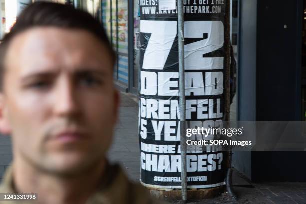 Grenfell fire poster is seen during the silent walk. Grenfell Tower fire survivors and bereaved relatives began a day of remembrance five years on...