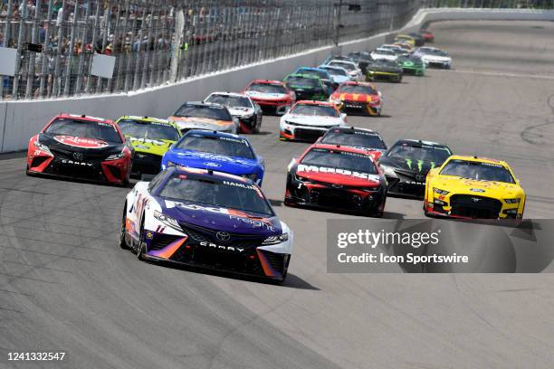 Denny Hamlin Joe Gibbs Racing TRD Toyota Camry NextGen races into turn one ahead of four-wide Christopher Bell Joe Gibbs Racing TRD Toyota Camry...