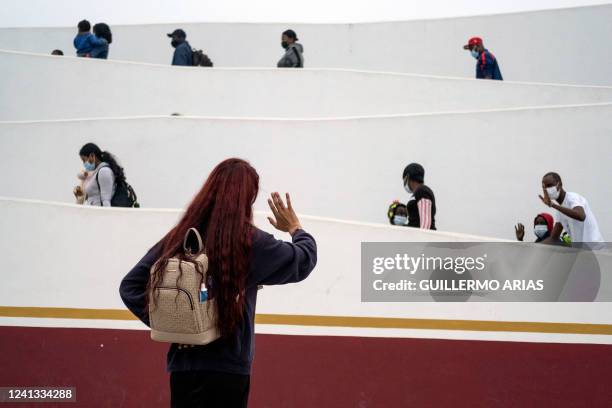 Mexican Brigitte Baltazar Lujano, a 35 year-old transgender woman, waves at asylum seekers walking at the crossing port to enter the United States...