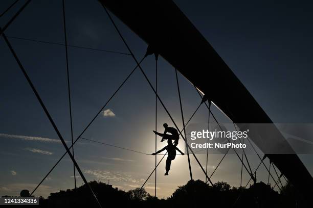 View of Krakow's Father Bernatek footbridge with an open air exhibition of the most amazing acrobatic sculptures that form the exhibition entitled...