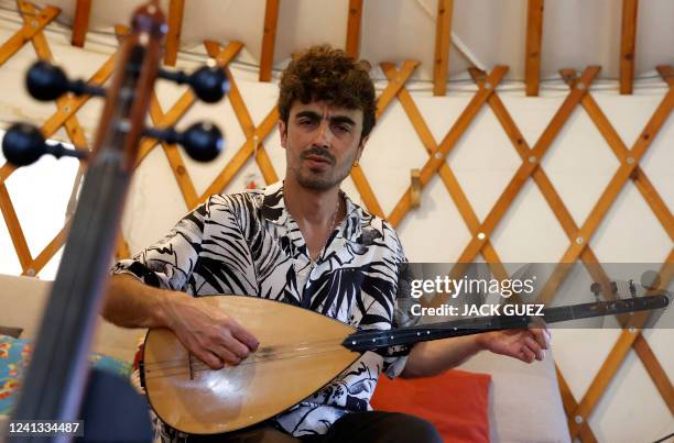 Israeli musician Mark Eliyahu plays his "saz", a kind of a long-necked lute, in his yurt in the northern moshav of Beitt Zaid in northern Israel, on...