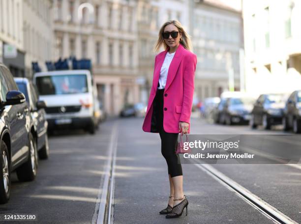 Sonia Lyson wearing Bottega Veneta heels, &other stories pants, Zara sunglasses and blazer and Jacquemus mini pink bag on May 26, 2020 in Berlin,...