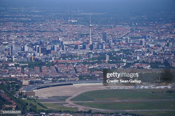 In this aerial view the broadcast tower at Alexanderplatz looms over the city center as former Tempelhof Airport stands in the foreground on June 1,...