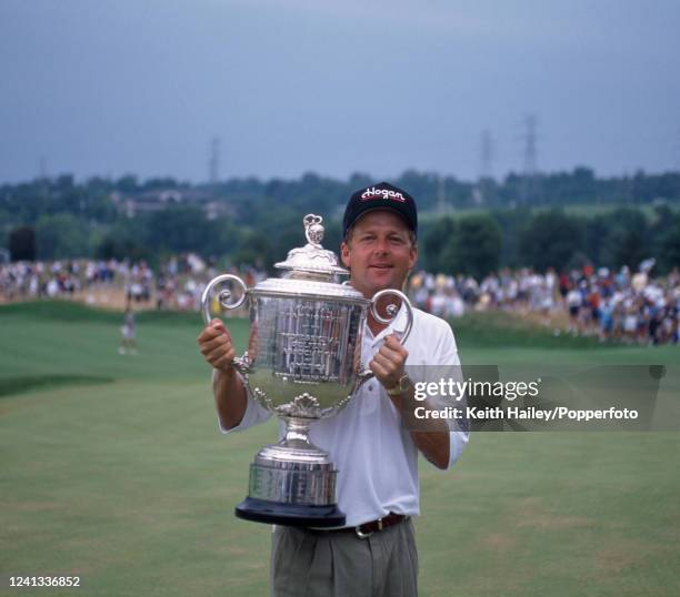 Mark Brooks of the United States celebrates with the trophy after winning the United States PGA Championship at Valhalla Golf Club on August 11, 1996...