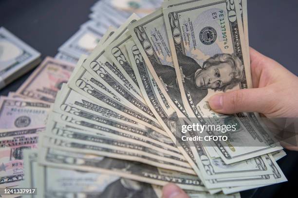 Staff member counts US dollar notes at a bank in Haian City, East China's Jiangsu Province, June 16, 2022. The US Federal Reserve raised its...