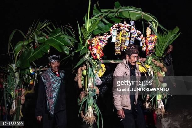 Members of the Tengger sub-ethnic group ascend the active Mount Bromo volcano to present offerings of rice, fruit, livestock and other items as part...