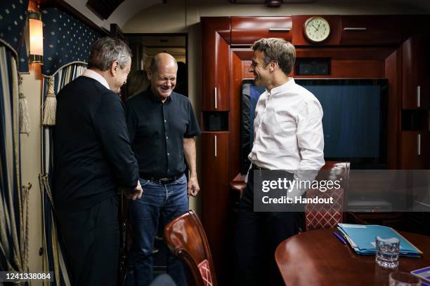 In this handout photo provided by the German Government Press Office , Italy's Prime Minister Mario Draghi, France's President Emmanuel Macron and...