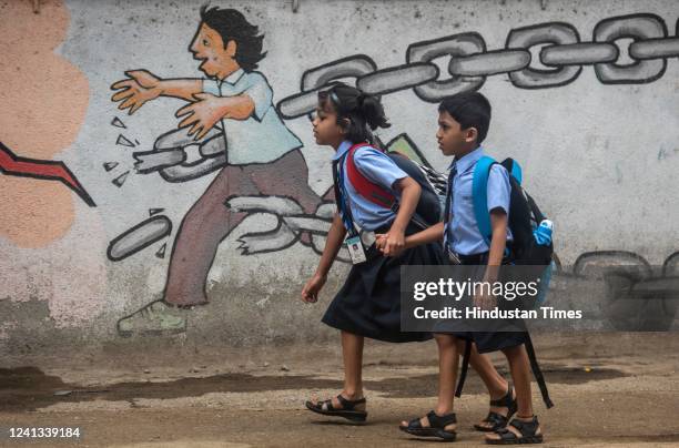 Children attend school on the first day of its reopening at Madhavrao Bhagwat High School, Vile Parle, on June 15, 2022 in Mumbai, India.