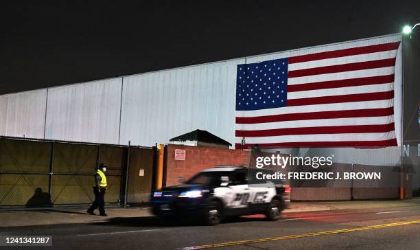 Security guard approaches a police vehicle driving past as Animal rights activists await the arrival of trucks carrying pigs to slaughter at the...