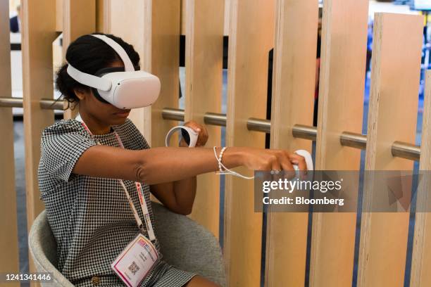 An attendee wearing a virtual reality headset tries out a VR application at the Orange SA booth at the Viva Technology Conference in Paris, France,...