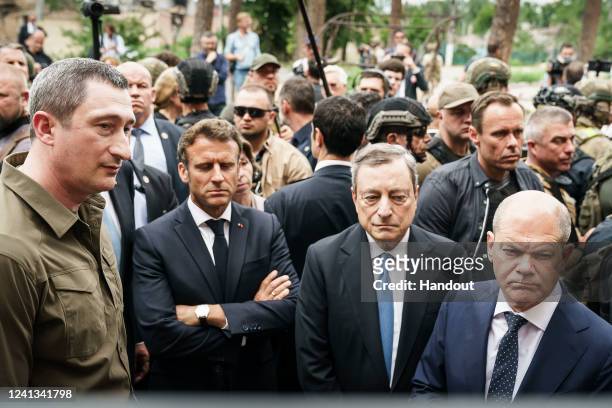In this handout photo provided by the German Government Press Office , France's President Emmanuel Macron, Italy's Prime Minister Mario Draghi and...
