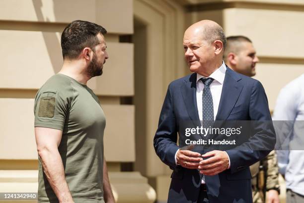 In this handout photo provided by the German Government Press Office , German Chancellor Olaf Scholz speaks with Ukrainian President Volodymyr...
