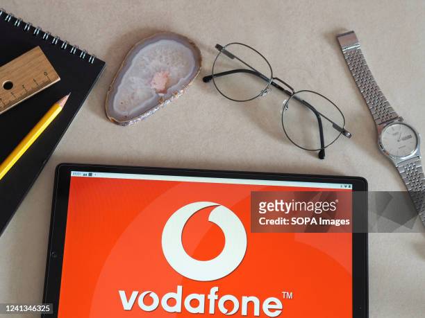 In this photo illustration Vodafone Group logo seen displayed on a tablet.