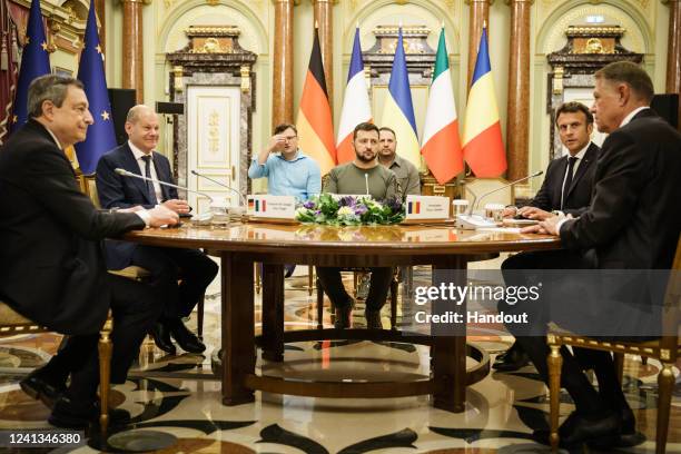 In this handout photo provided by the German Government Press Office , German Chancellor Olaf Scholz sits at the table with Mario Draghi , Italy's...