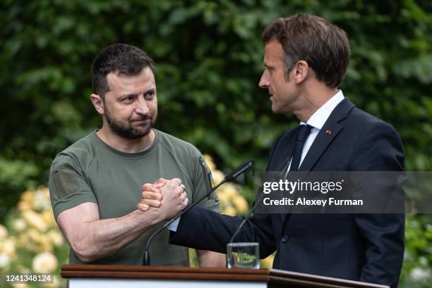 Ukrainian President Volodymyr Zelensky and Frances President Emmanuel Macron shake hands after a press conference on June 16, 2022 in Kyiv, Ukraine....