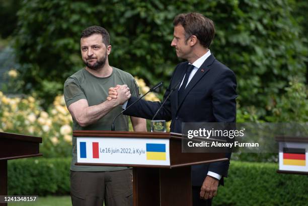 Ukrainian President Volodymyr Zelensky and Frances President Emmanuel Macron shake hands after a press conference on June 16, 2022 in Kyiv, Ukraine....