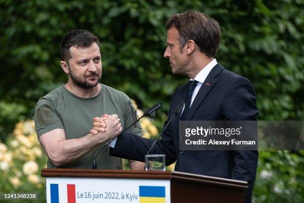 Ukrainian President Volodymyr Zelensky and Frances President Emmanuel Macron shake hands after a press conference on June 16, 2022 in Kyiv, Ukraine....