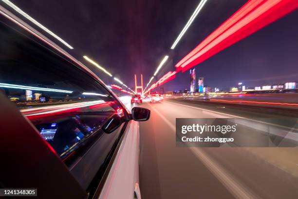 abstract background of speed traffic light trails with circle bokeh - car light trails stock pictures, royalty-free photos & images