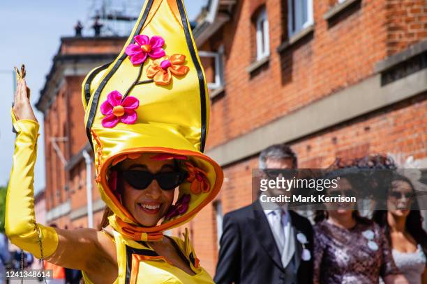 Racegoer Tracy Rose arrives at Royal Ascot wearing an elaborate yellow hat for Ladies Day on 16th June 2022 in Ascot, United Kingdom. This year's...