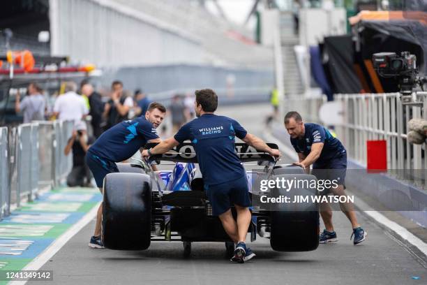 Pit crew move the car of Williams' Canadian driver Nicholas Latifi during previews ahead of the F1 Grand Prix of Canada at Circuit Gilles Villeneuve...