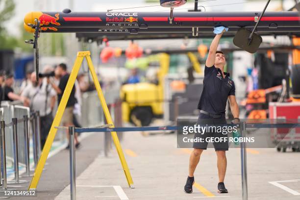 Member of the Red Bull Racing crew cleans equipment in the pits at the F1 Grand Prix of Canada at Circuit Gilles-Villeneuve in Montreal, Quebec on...