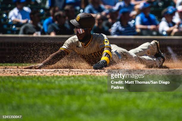 Jurickson Profar of the San Diego Padres slides into home plate in the fourth inning against the Chicago Cubs on June 16, 2022 at Wrigley Field in...