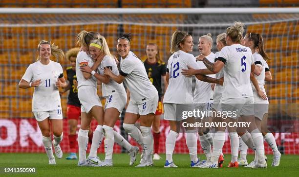 England's players celebrating after scoring during the friendly match between Belgium's national women's soccer team the Red Flames and the English...