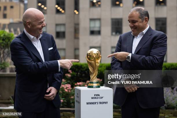 President Gianni Infantino and CONCACAF President Victor Montagliani pose with the FIFA World Cup trophy during an event in New York after an...