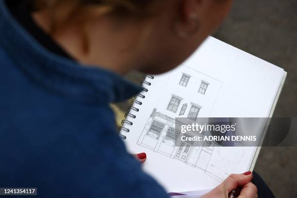 Artist Lydia Wood makes a drawing of The Atlas pub in Earls Court in west London on May 26, 2022. - The 28-year-old artist has built up a TikTok and...