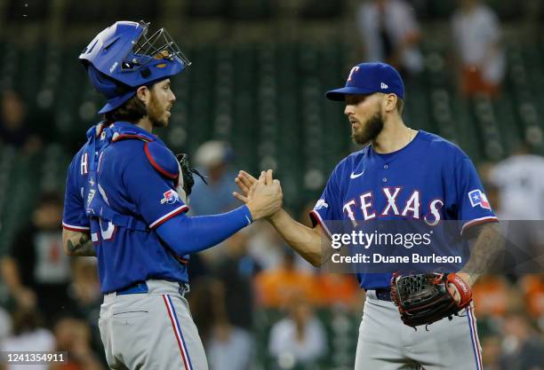 Catcher Jonah Heim and pitcher Joe Barlow of the Texas Rangers celebrate a 3-1 win over the Detroit Tigers at Comerica Park on June 16 in Detroit,...