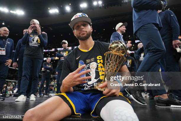 Stephen Curry of the Golden State Warriors celebrates on stage with the Bill Russell Finals MVP Trophy after winning during Game Six of the 2022 NBA...