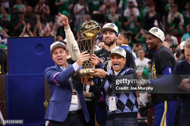 Owners of the Golden State Warriors, Joe Lacob and Peter Guber, hold The Larry OBrien trophy after Game Six of the 2022 NBA Finals on June 16, 2022...