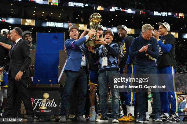 Deputy Commissioner Mark Tatum presents The Larry OBrien trophy to Owners of the Golden State Warriors, Joe Lacob and Peter Guber after Game Six of...