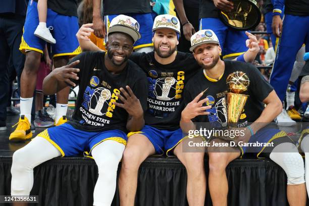 Draymond Green, Klay Thompson and Stephen Curry of the Golden State Warriors celebrate with the Bill Russell Finals MVP Trophy after winning during...